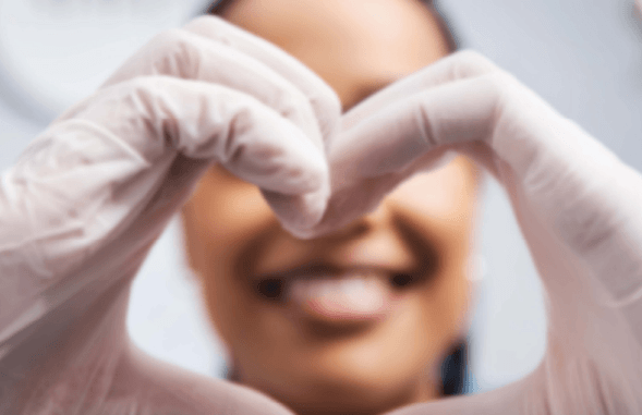 medical professional showing heart symbol with hands